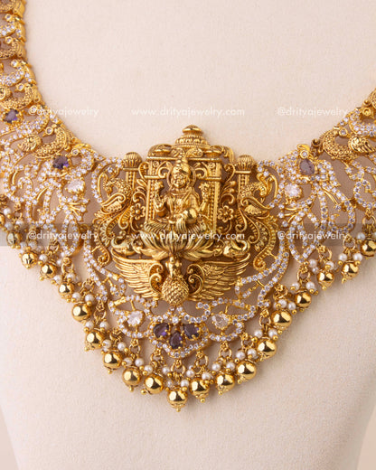 Close-up of temple-style Nakshi necklace with intricate peacock motifs and gold bead accents.