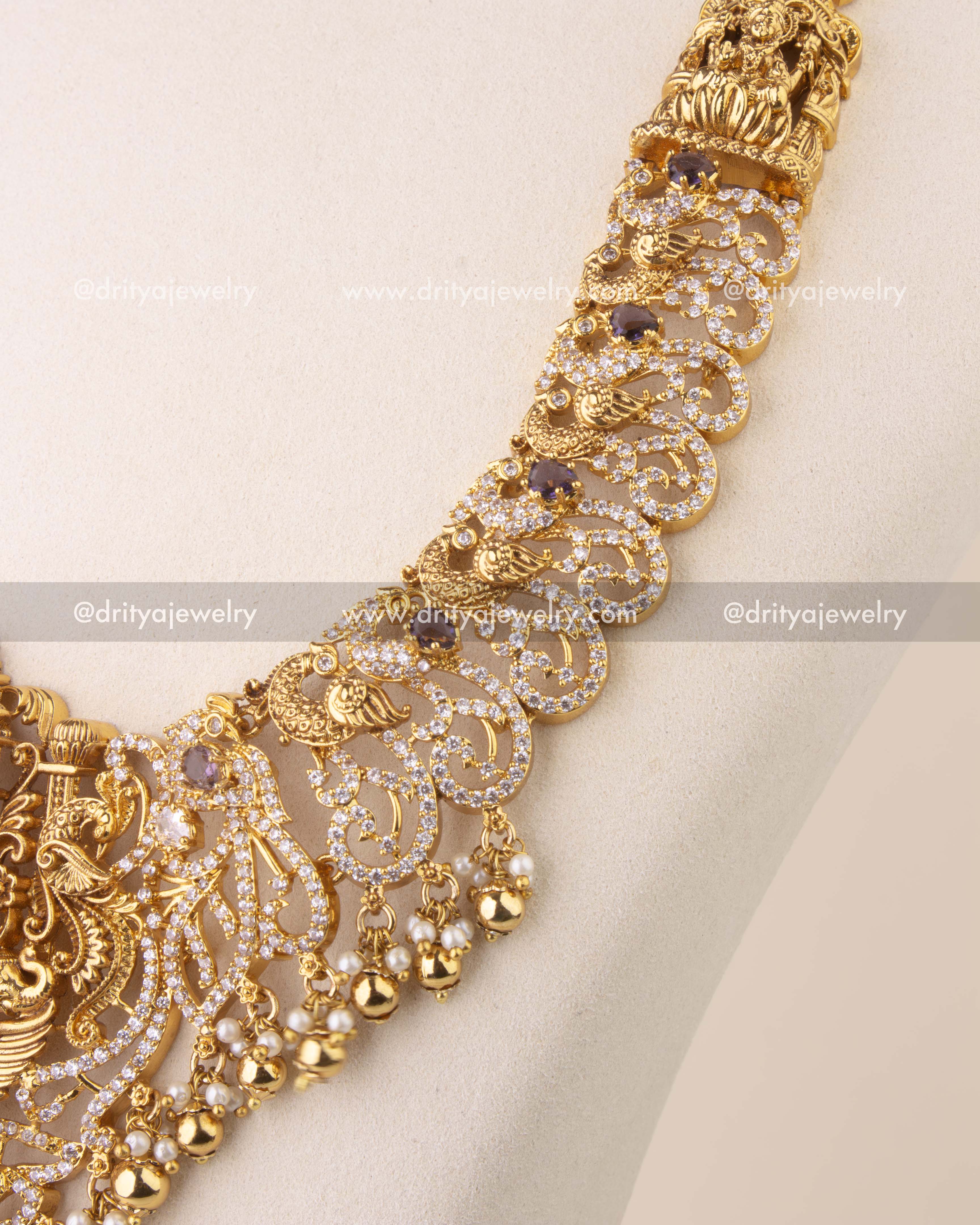 Close-up of temple-style Nakshi necklace with intricate peacock motifs and gold bead accents.