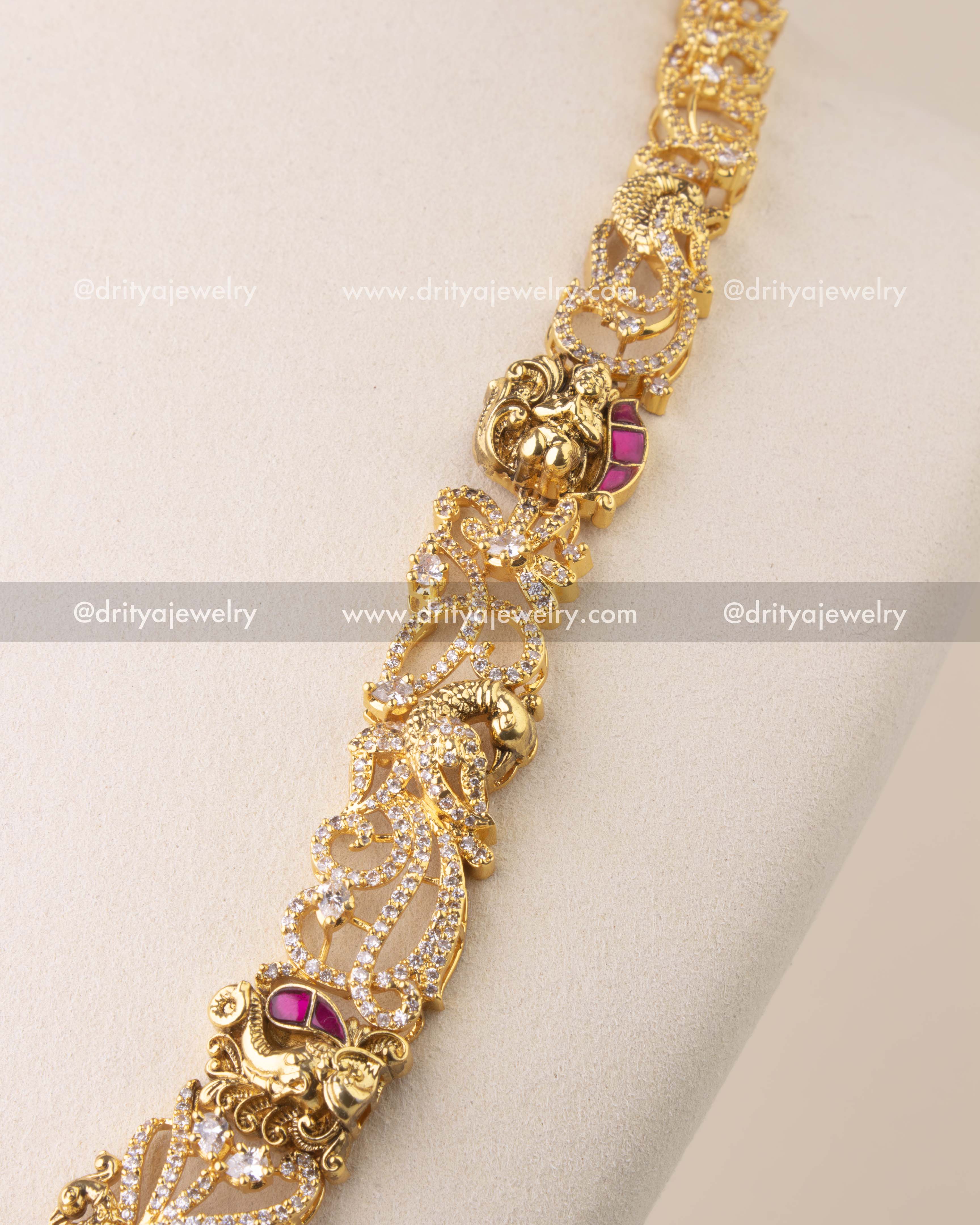 Close-up of Kemp temple necklace with elephant and peacock Nakshi motifs, embellished with CZ stones.