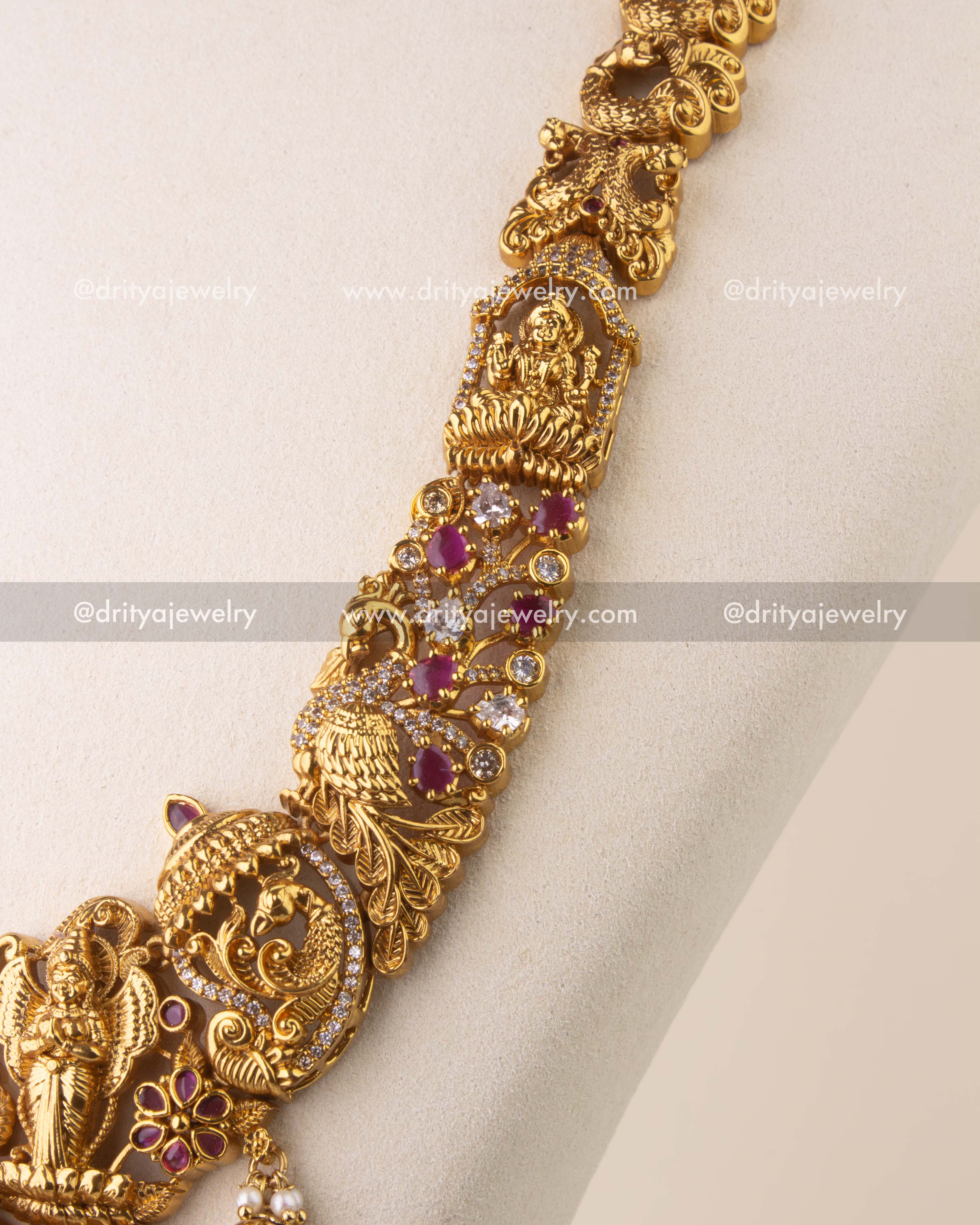 Traditional antique gold jhumka earrings with Lakshmi motif, Kemp accents, pearls, and golden bead drops.