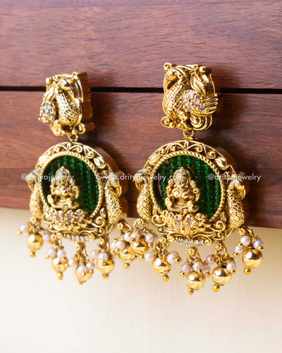 Antique earrings with green background beads and classic golden bead danglers.