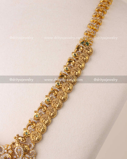 Close-up of Kasulu chain long necklace with Nakshi coin details, green accents, and CZ stone embellishments