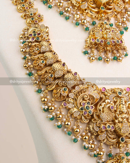 Close-up of Nakshi temple long necklace with Lakshmi pendant, emerald green stones and CZ accents.