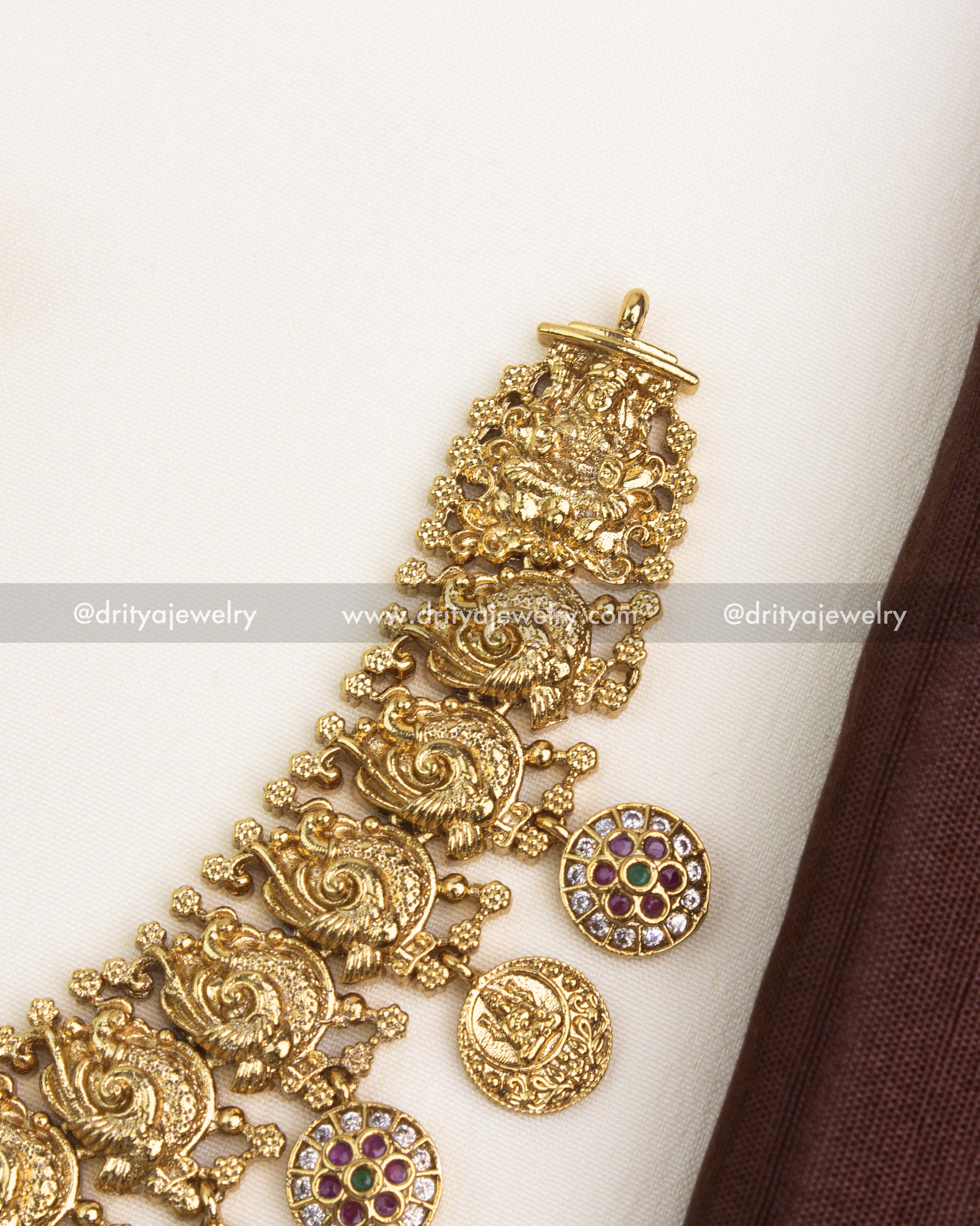 Intricate temple engravings with embossed Goddess Lakshmi coins and floral CZ accents.