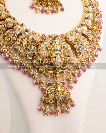 Close-up of Nakshi temple necklace with CZ stones and ruby pink bead hangings.