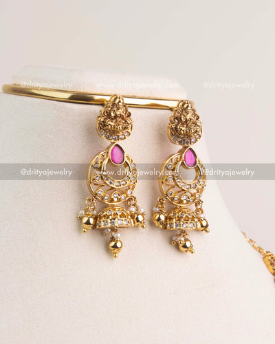 Matching gold-plated Lakshmi jhumka earrings with ruby accents and pearl-gold ball drops.