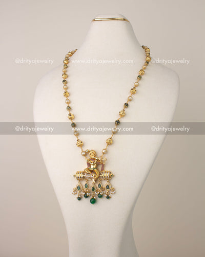 Premium temple jewelry necklace with Lord Krishna pendant and green bead drops.