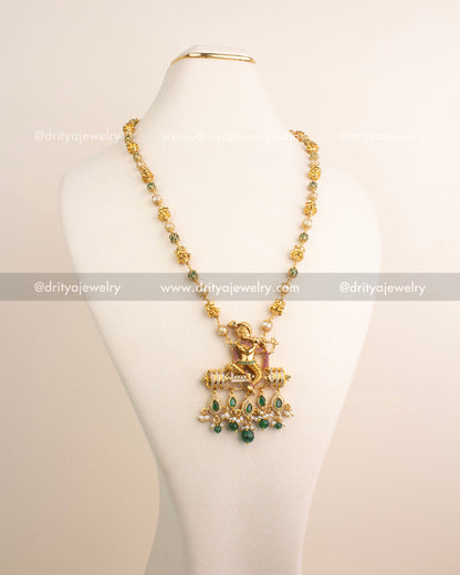 Premium temple jewelry necklace with Lord Krishna pendant and green bead drops.