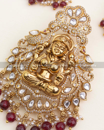 Close-up showing Lakshmi idol, polki kundan stones, CZ borders, and ruby bead hangings with pearls