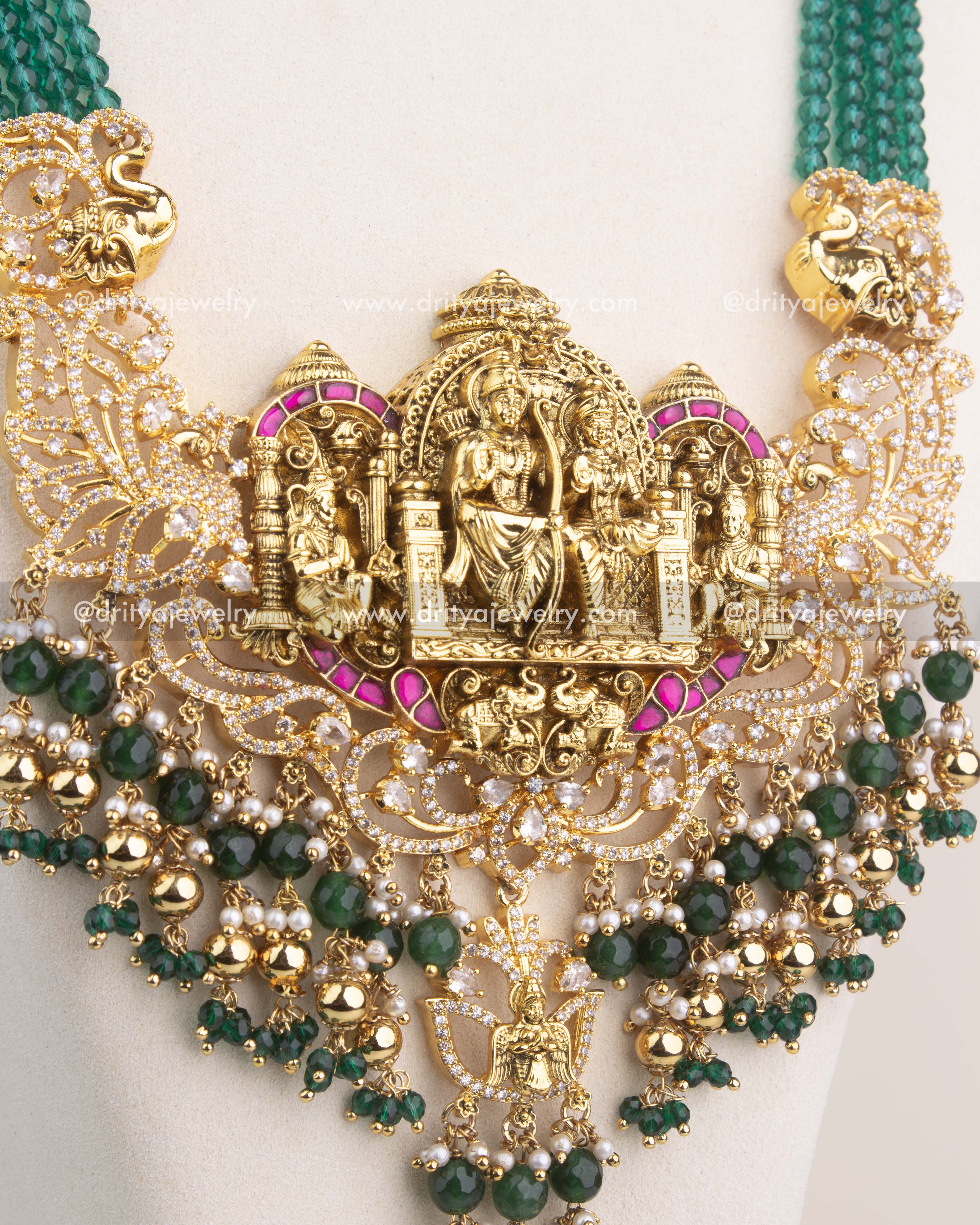 Detailed view of Ram Parivar Nakshi pendant with intricate carvings, Kemp stones, and pearl hangings.