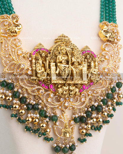 Detailed view of Ram Parivar Nakshi pendant with intricate carvings, Kemp stones, and pearl hangings.