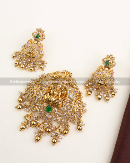 Premium gold-plated temple jewelry pendant set with Lakshmi motif, CZ stones, and green teardrop center stone.
