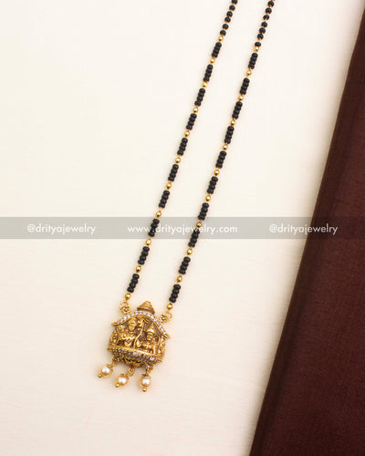 Antique gold pendant featuring god idol motif, CZ accents, and pearl hangings.