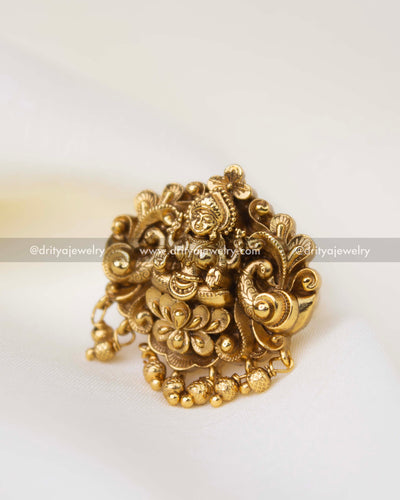 Traditional temple finger ring featuring goddess motif and decorative gold bead hangings