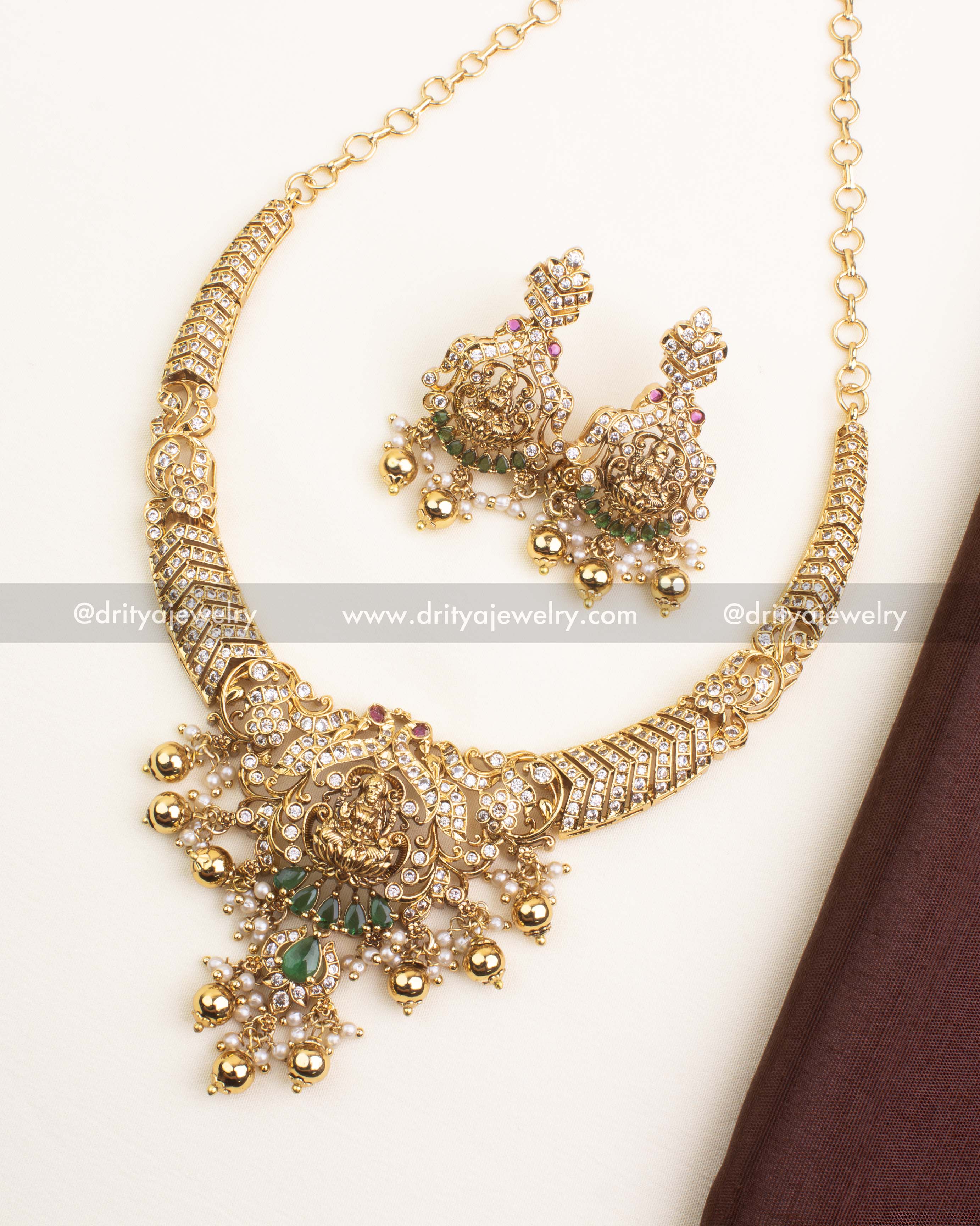 Premium temple short necklace featuring Lakshmi pendant, CZ stones, and green teardrop accents.