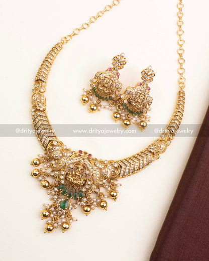 Premium temple short necklace featuring Lakshmi pendant, CZ stones, and green teardrop accents.