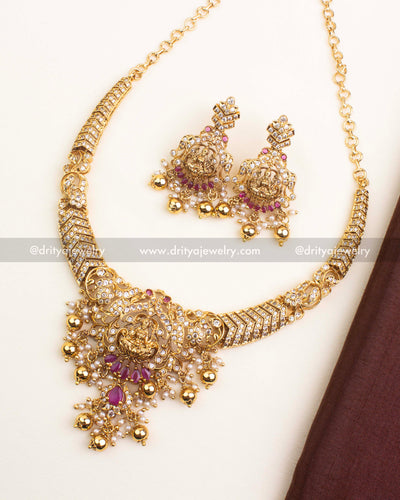 Premium temple short necklace featuring Goddess Lakshmi motif with red stones and pearl drops.