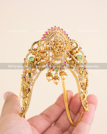 Premium gold-plated aravanki with Goddess Lakshmi motif, pink and green stones, and CZ detailing.