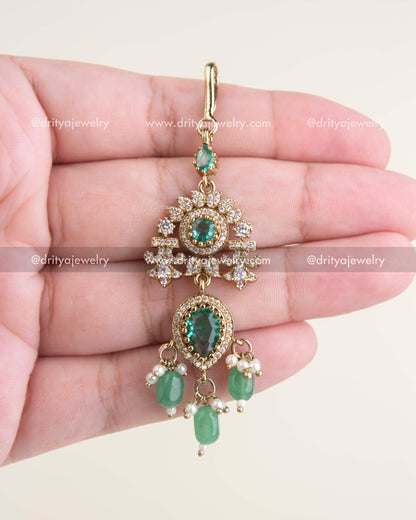 Russian emerald maang tikka with AD stones, floral motif, and Victorian gold polish.