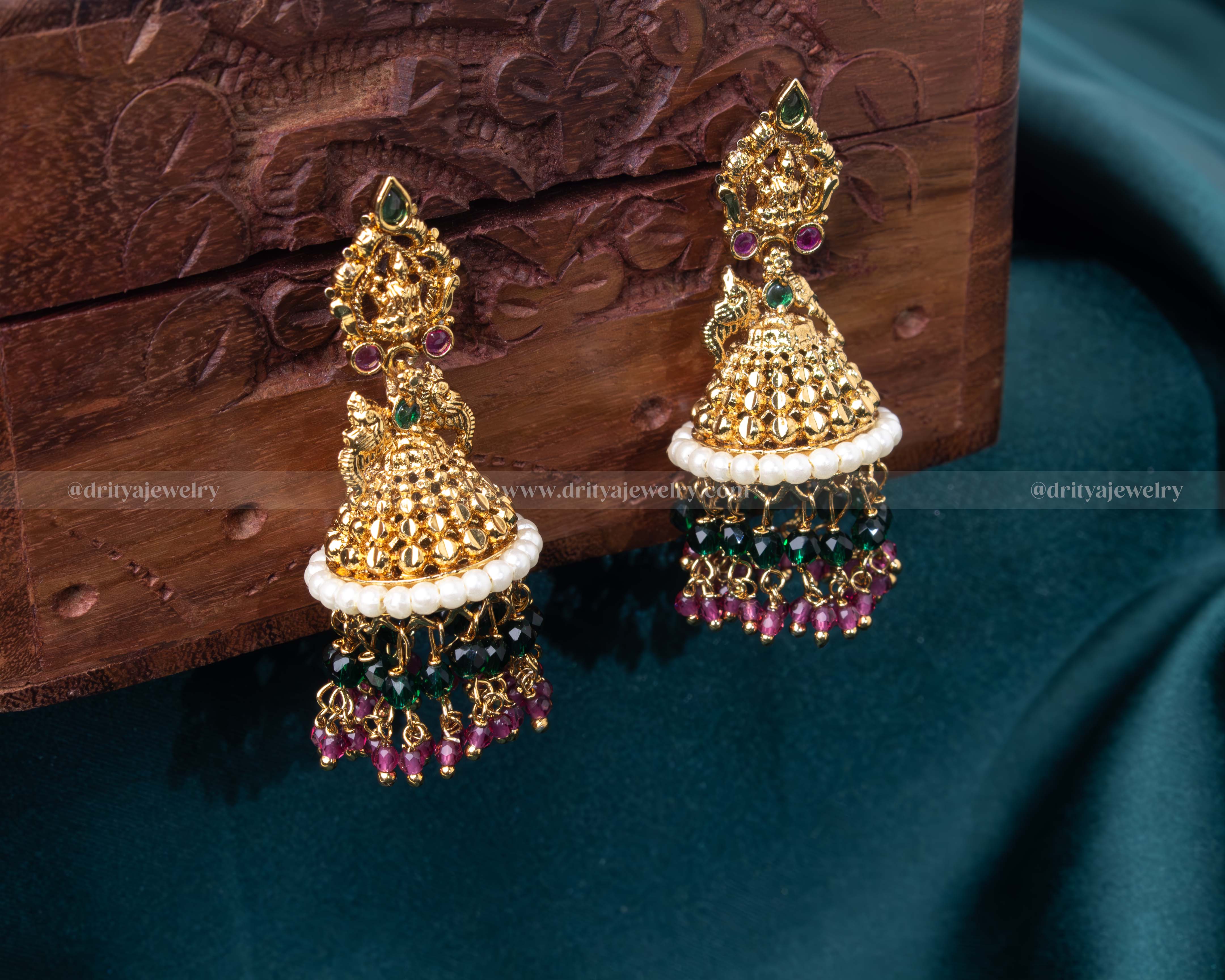 Gold-tone temple jhumka earrings adorned with faux gemstones and colorful bead hangings, perfect for traditional events.