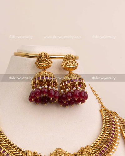 Temple jhumka earrings with Lakshmi top and clusters of ruby red beads.