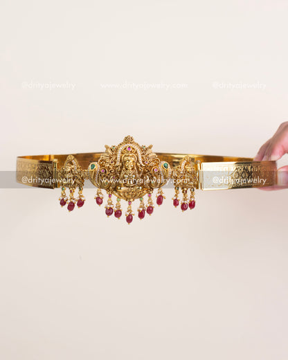 Antique gold temple waist belt with Goddess Lakshmi motif and ruby bead hangings.