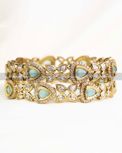 Mint green AD stone Victorian bangles with teardrop design and intricate gold finish from Dritya Jewelry.