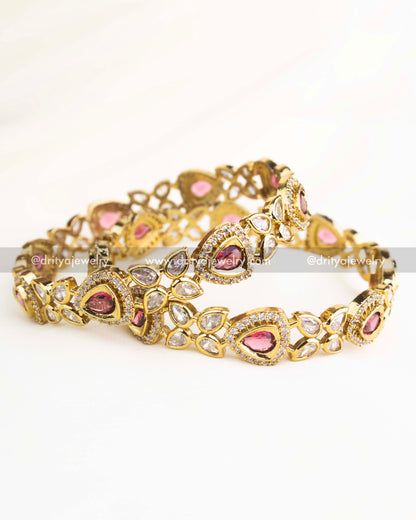 Victorian-style bangles with ruby red teardrop stones and white AD detailing in gold-plated finish.
