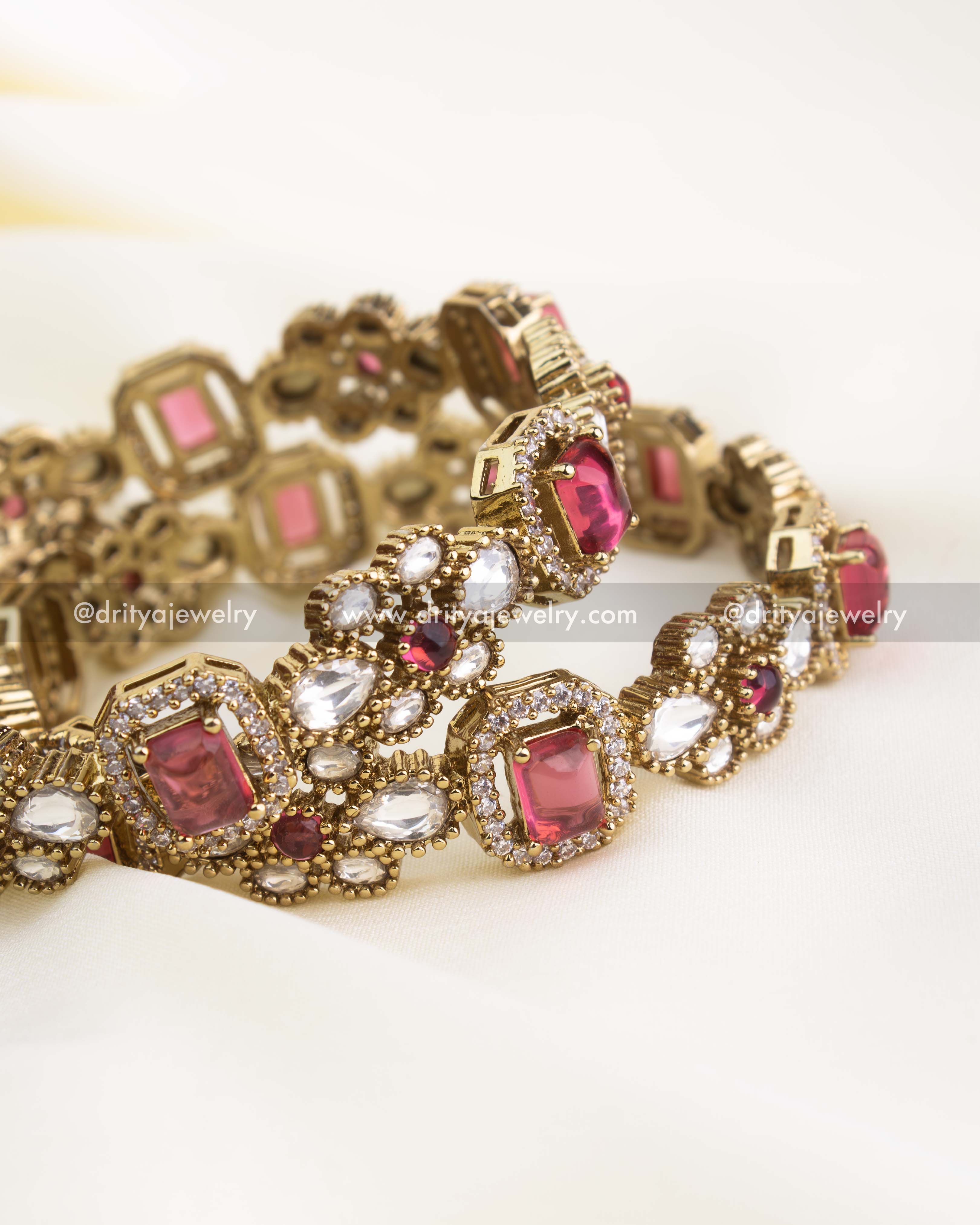 Handcrafted imitation bangles with ruby red rectangular stones, polki kundan embellishments, and antique gold finish.