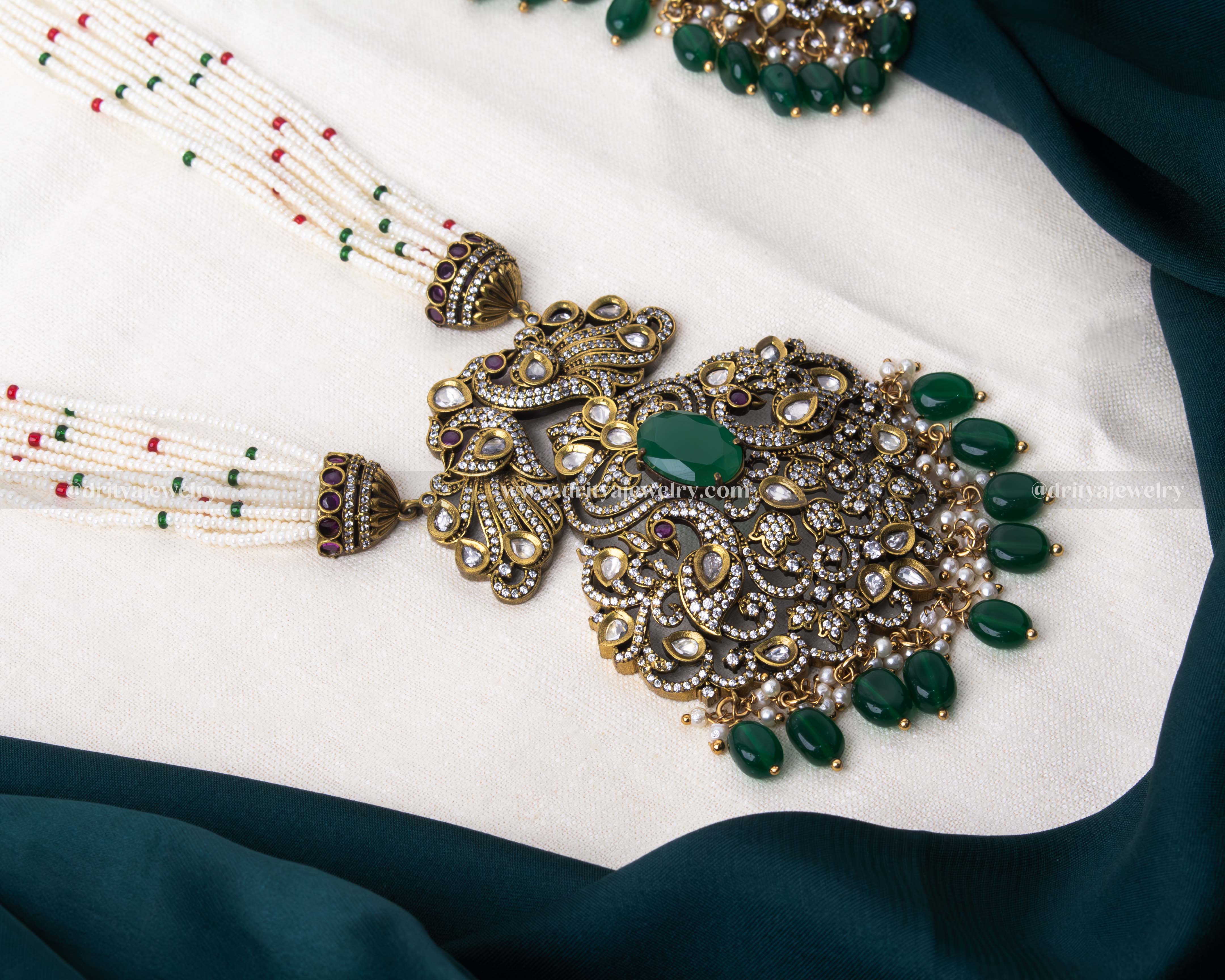 Exquisite gold-plated necklace set with multi-strand beads and an ornate green stone pendant, paired with matching earrings, perfect for weddings and special occasions.