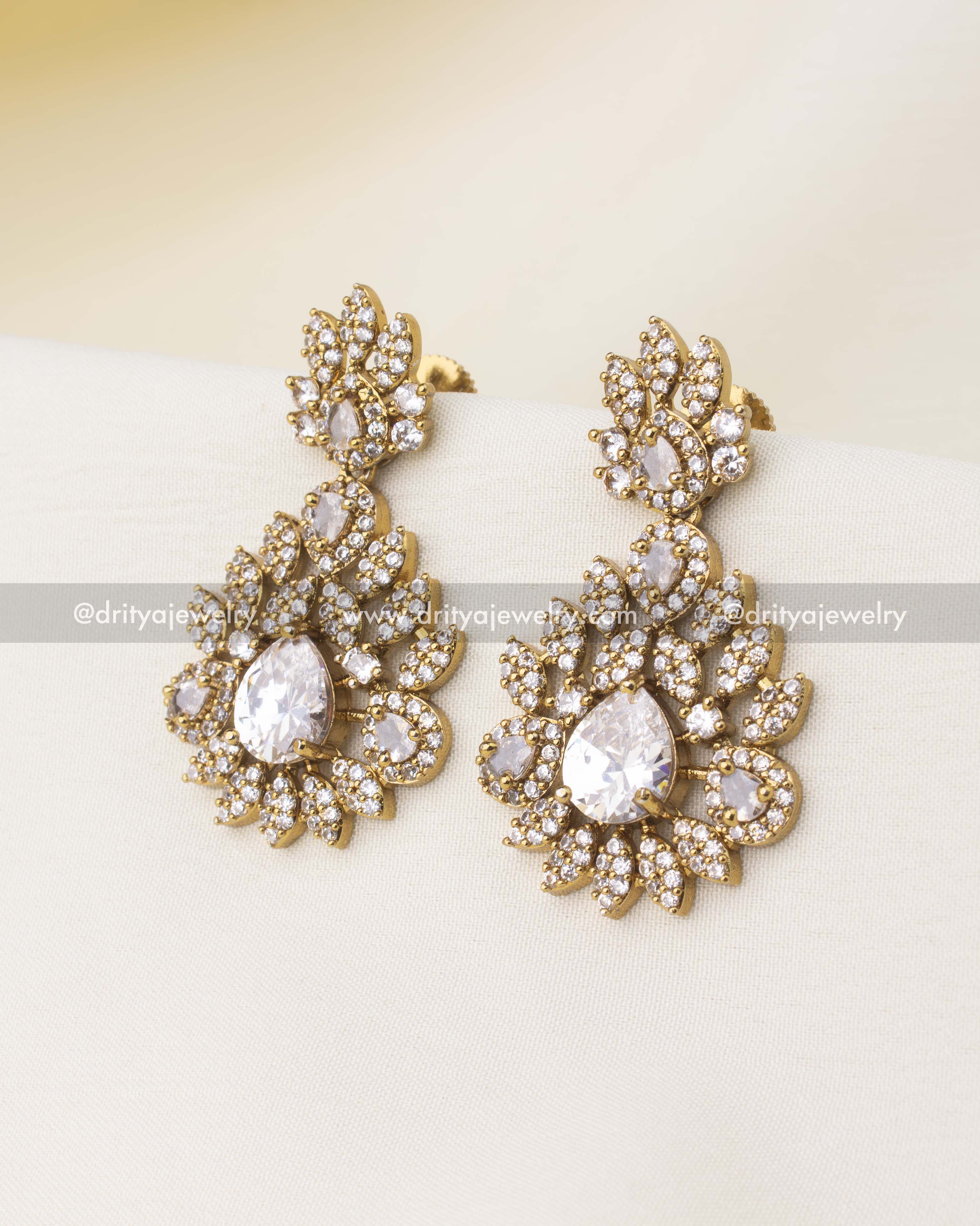 Matching Victorian earrings with pear-cut diamond-alike CZ stones and floral detailing.