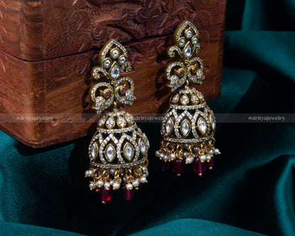 Elegant gold-plated Victorian jhumka earrings with faux ruby and pearl details, ideal for traditional events and formal gatherings.