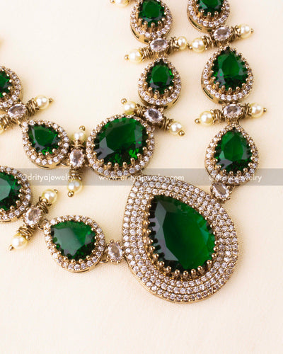 Premium Victorian layered short necklace with emerald-colored stones, zircon detailing, and pearl embellishments, paired with statement earrings.
