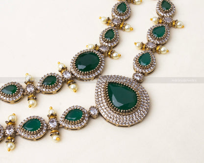 Premium Victorian layered short necklace with emerald-colored stones, zircon detailing, and pearl embellishments, paired with statement earrings.