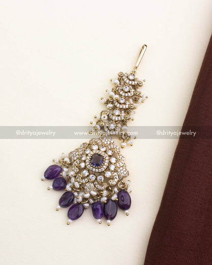 Victorian-style maang tikka with deep purple stones, CZ sparkle, and pearl accents.