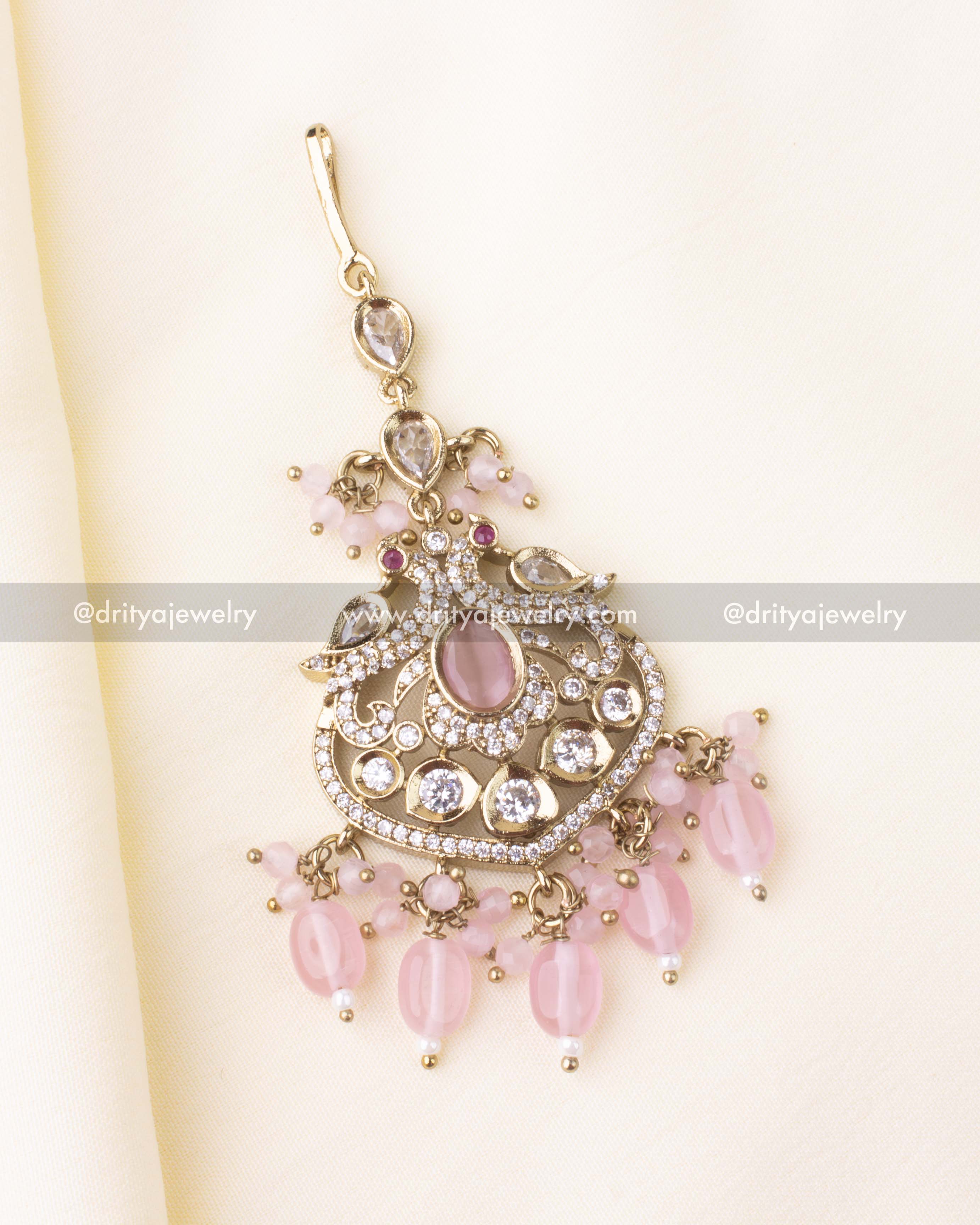 Antique gold Victorian maang tikka featuring blush pink center stone and bead hangings.