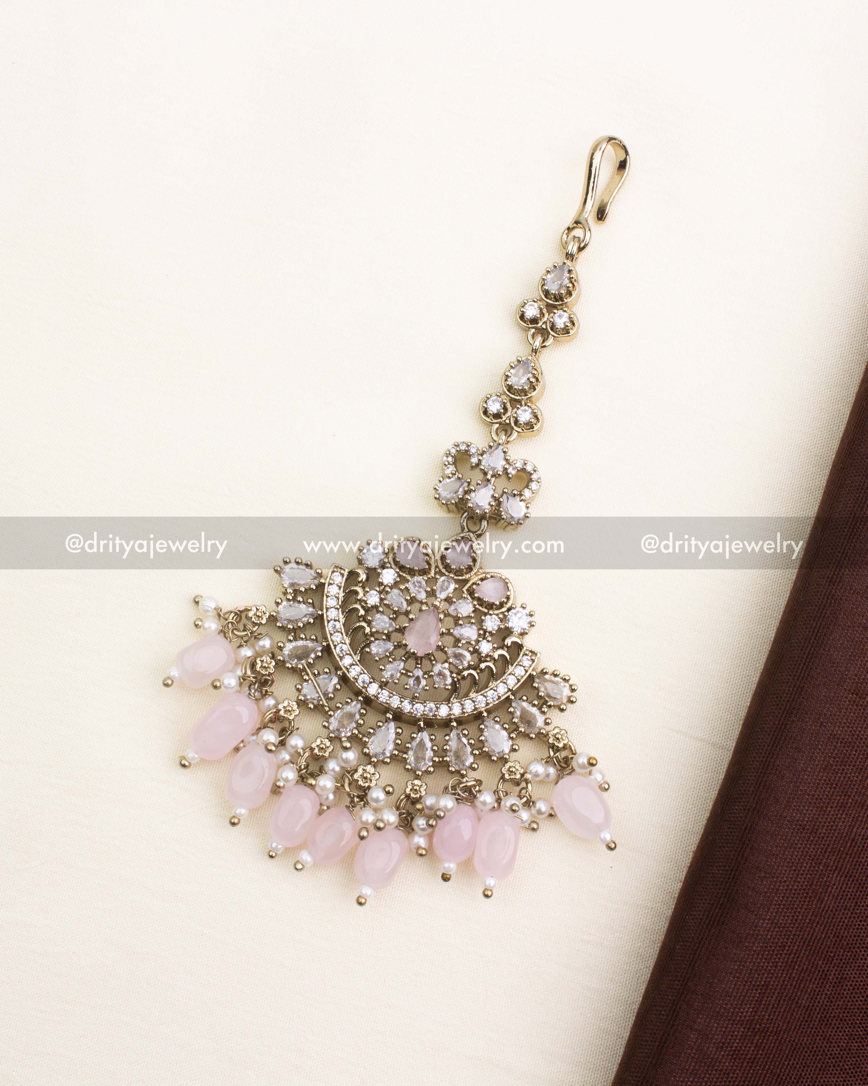 Premium Victorian maang tikka with blush pink beads and CZ detailing.