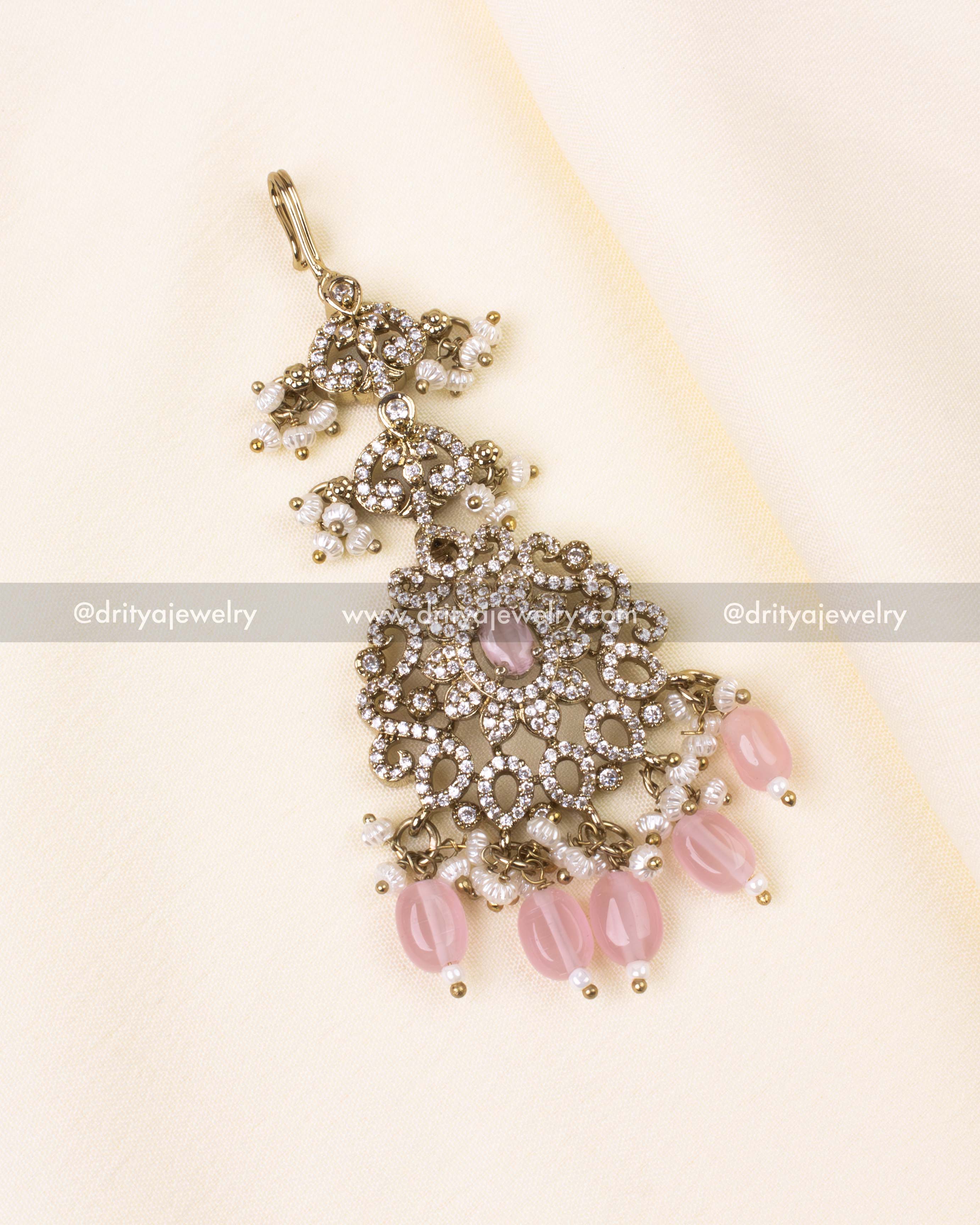 Blush pink maang tikka featuring Victorian filigree and pearl bead drops.