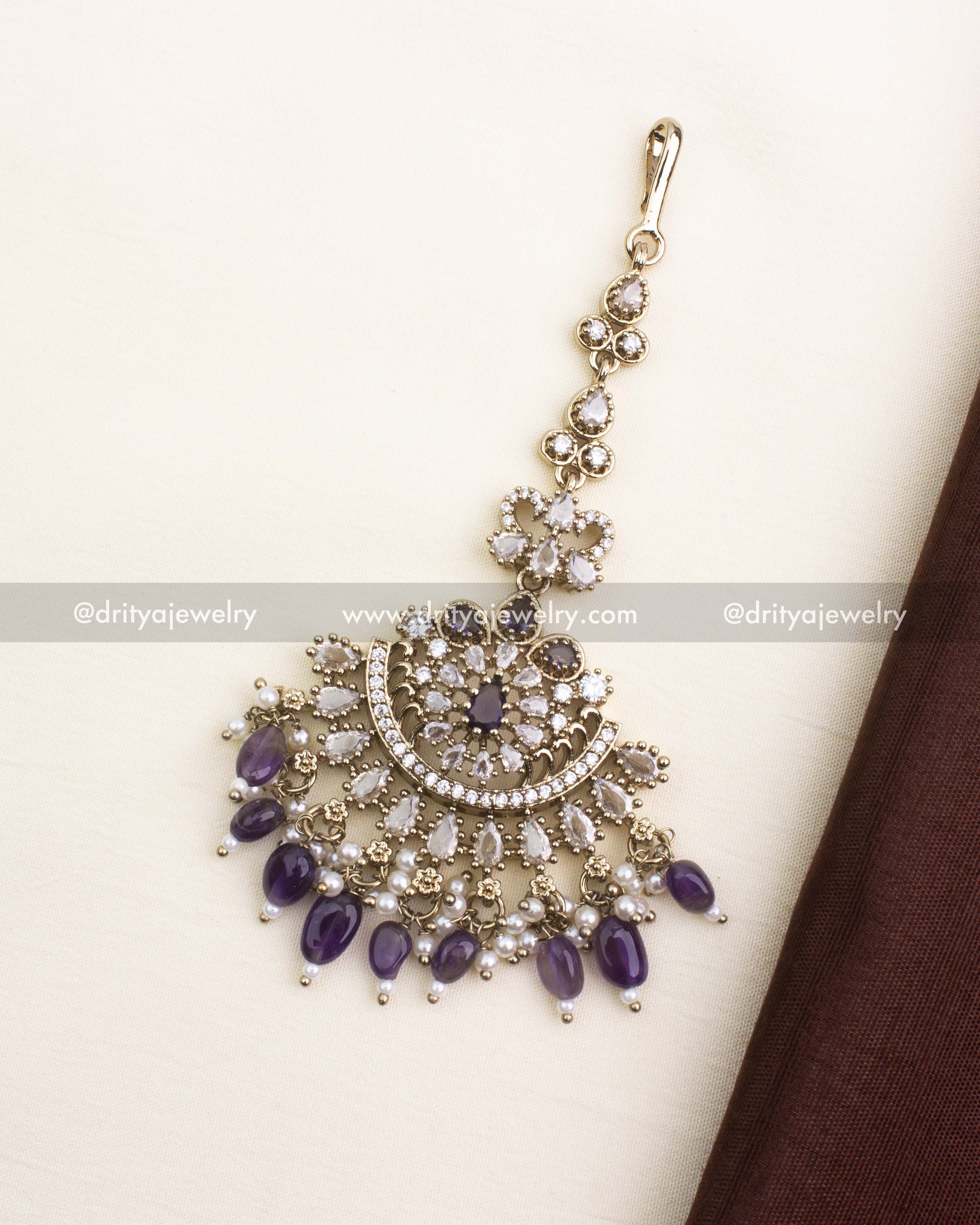 Statement Victorian maang tikka with purple bead drops and CZ embellishments.