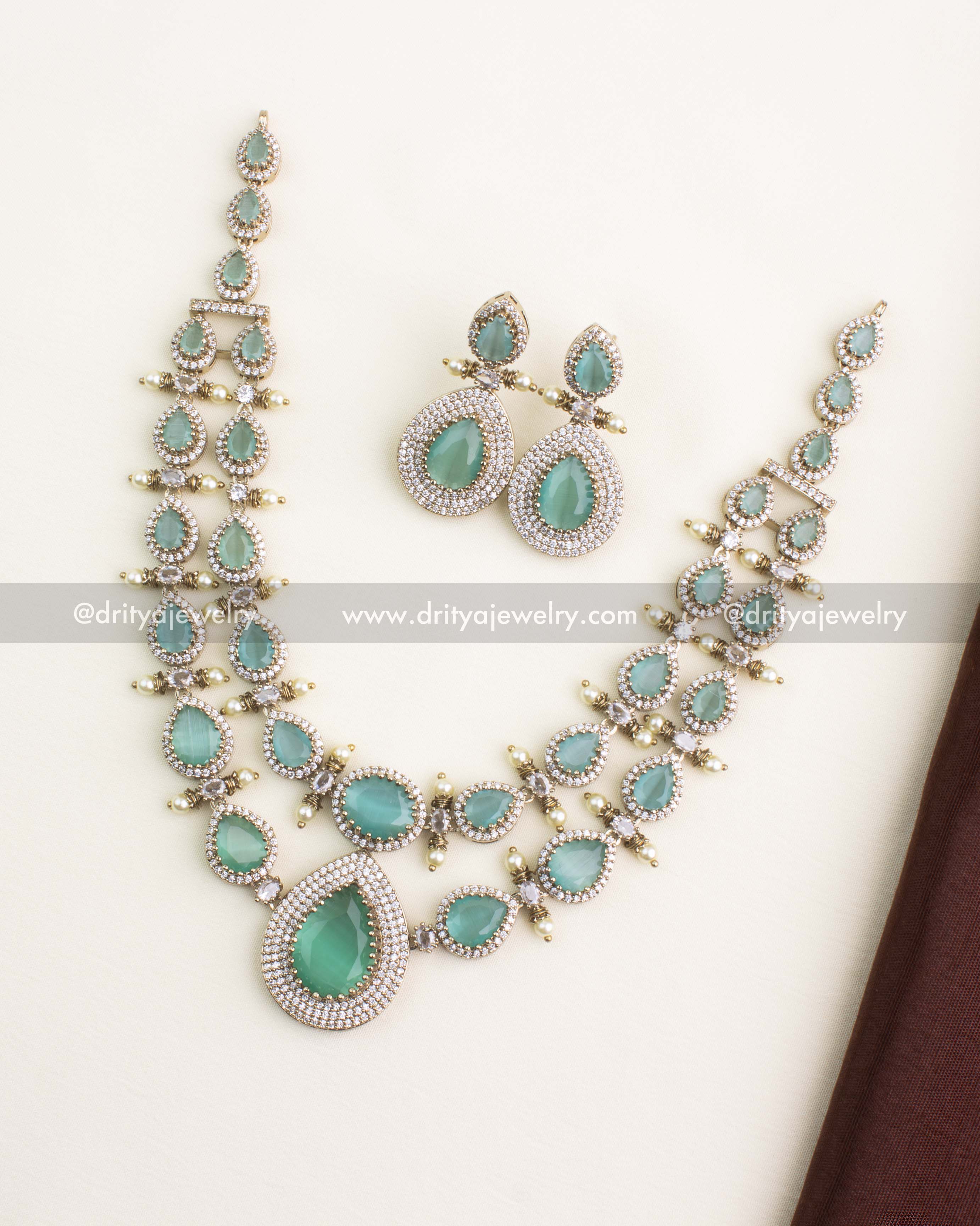 Full view of Victorian layered necklace set with mint green stones and matching earrings.