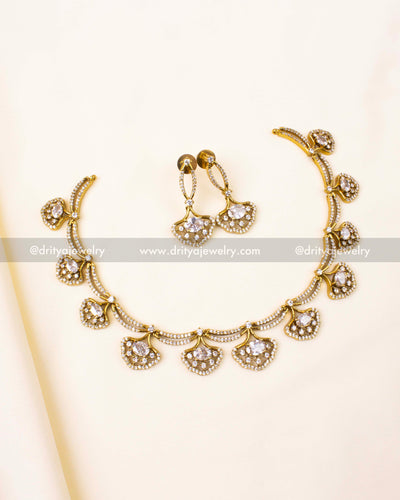 Short necklace with CZ stones in gold finish mimicking diamonds.