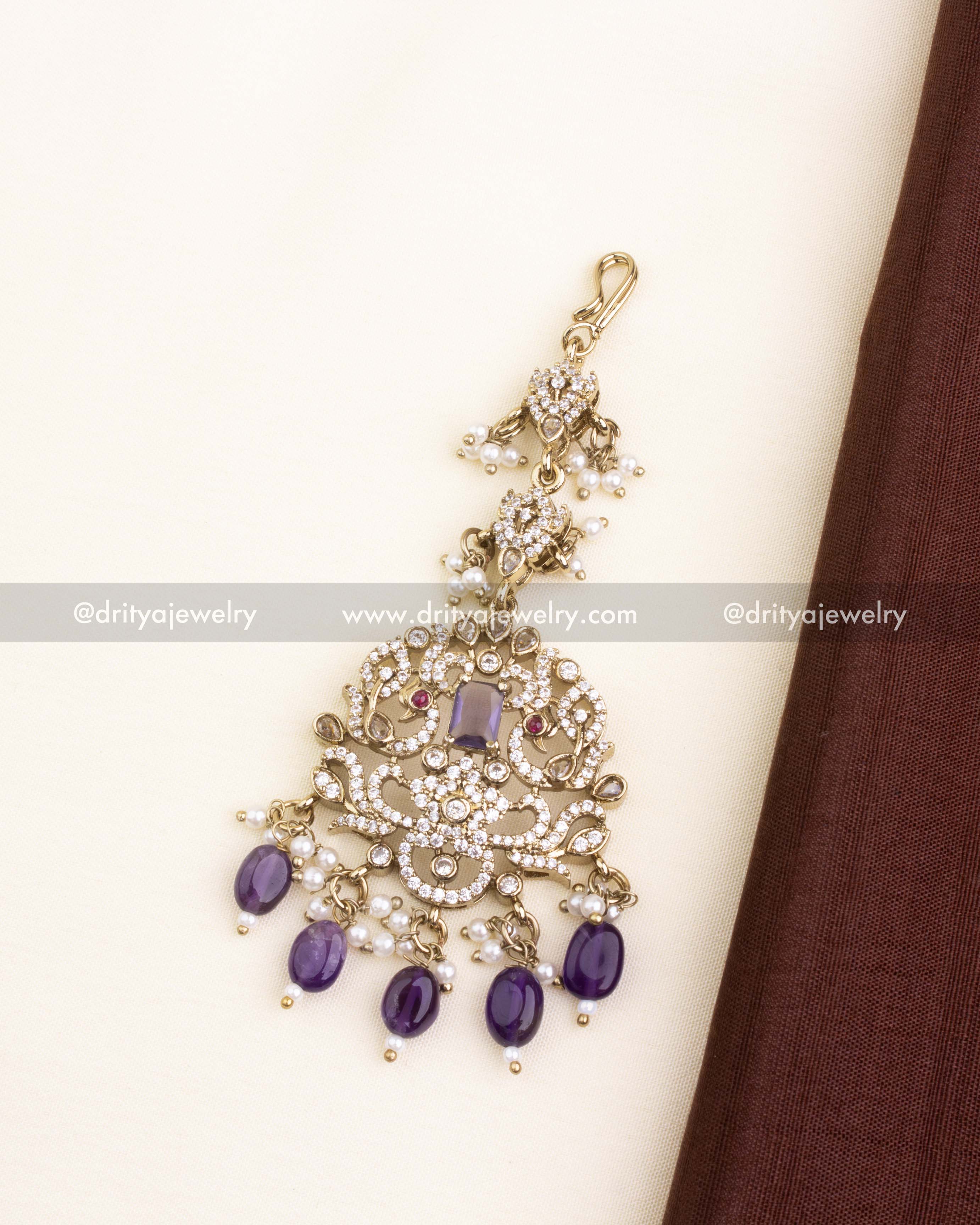 Purple and CZ embellished maang tikka with pearl bead hangings.