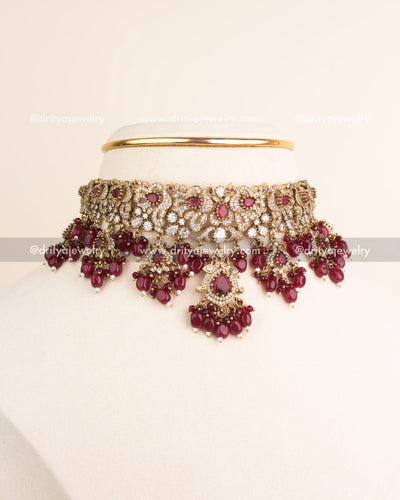 Ruby red Victorian choker necklace paired with matching earrings.