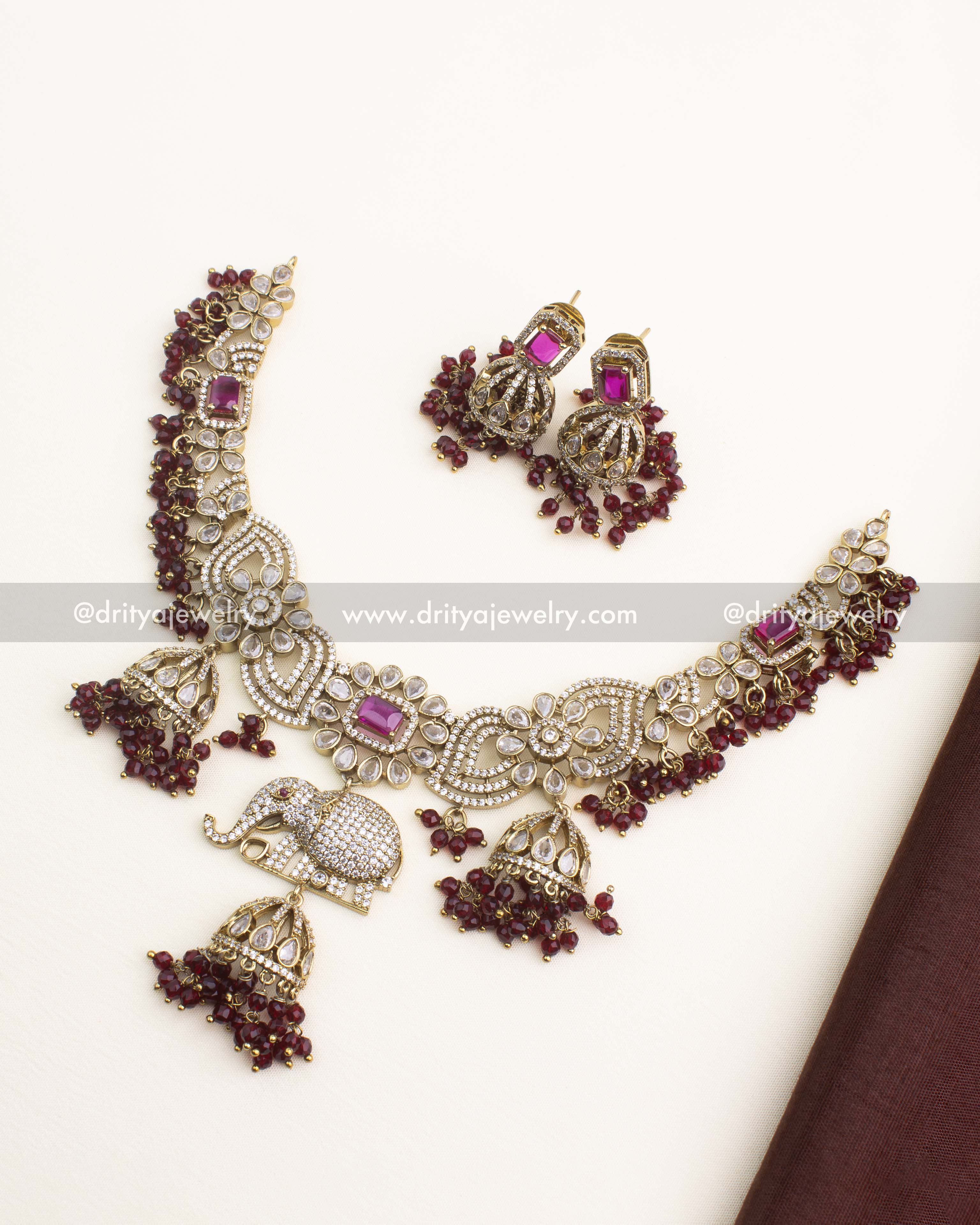 Premium Victorian short necklace set with ruby stones, elephant motif centerpiece, and matching earrings.