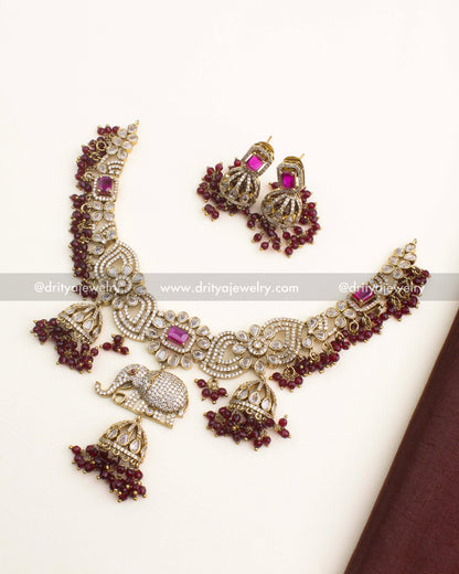 Premium Victorian short necklace set with ruby stones, elephant motif centerpiece, and matching earrings.