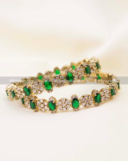 Close-up of emerald green stone Victorian polish bangles with intricate CZ cluster setting
