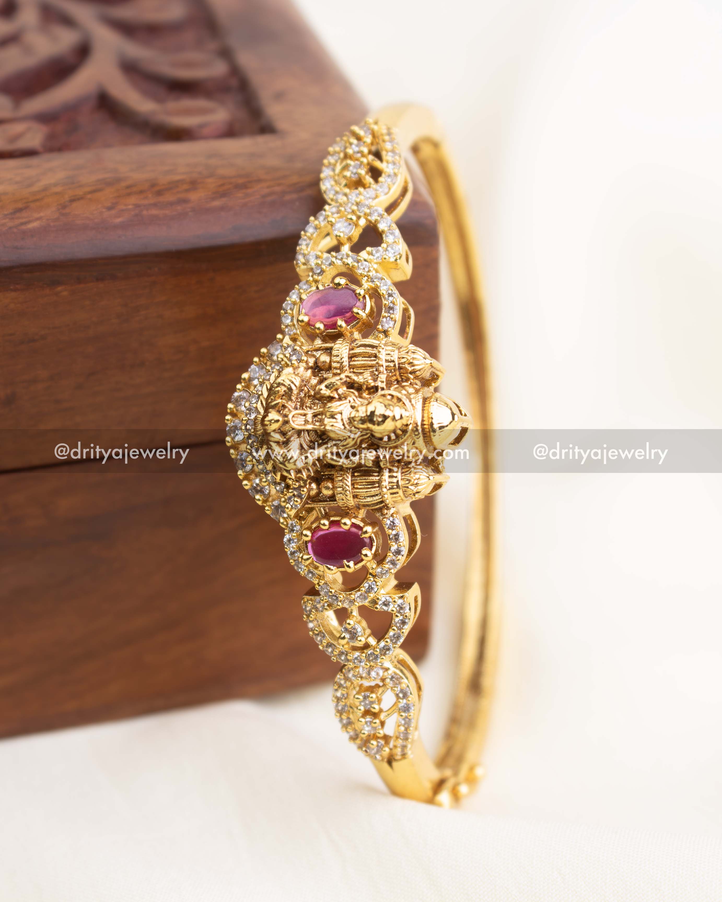 Close-up side shot showing ruby red stones and nakshi temple detailing.