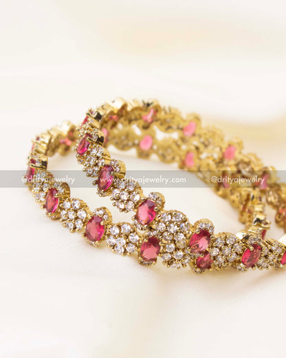 Close-up of ruby red stone Victorian polish bangles with intricate CZ cluster work