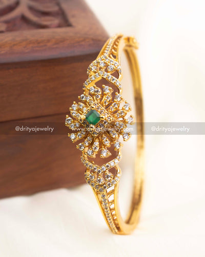 Premium gold-plated openable CZ kada with emerald green stone centerpiece and crystal embellishments.