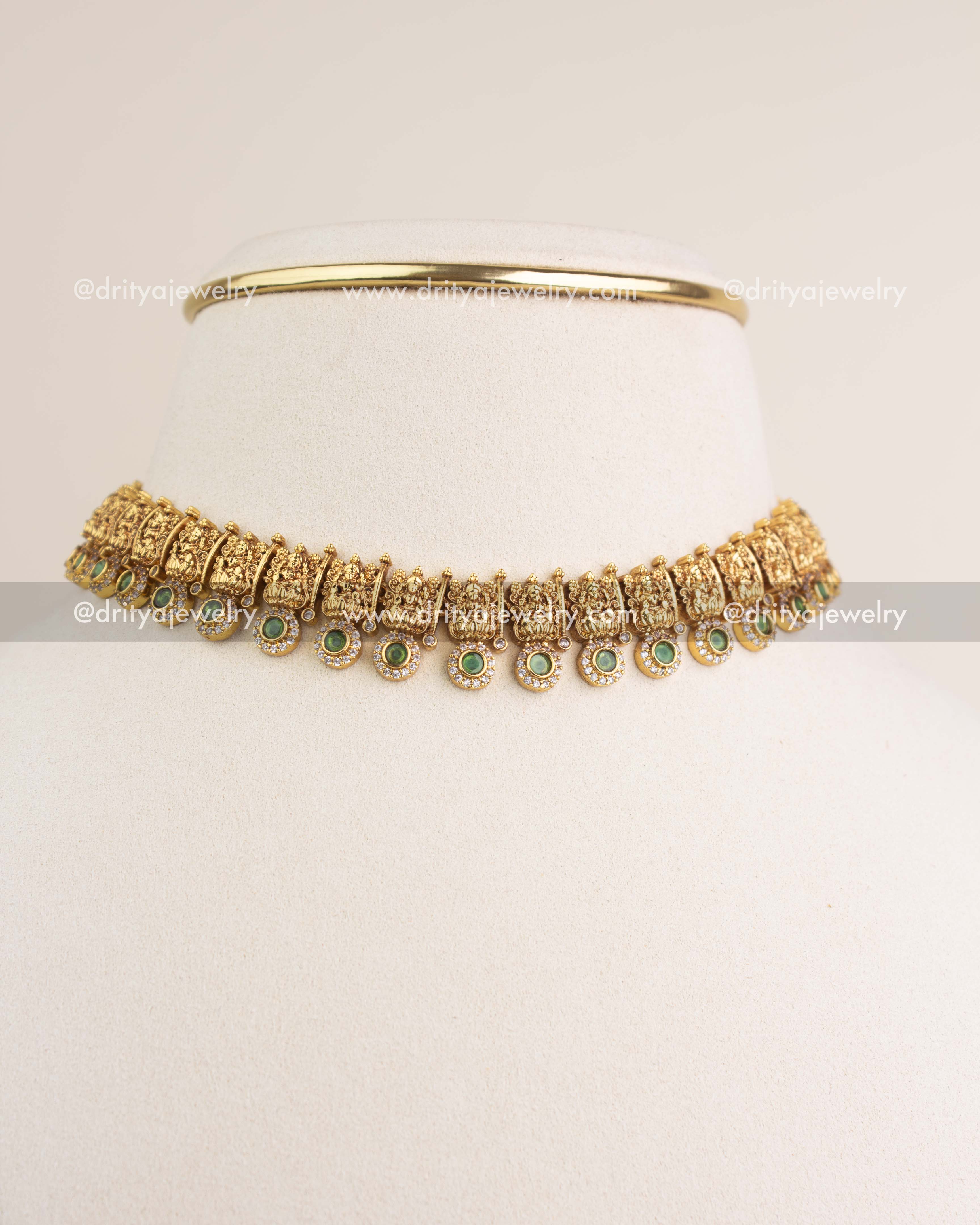 Green temple choker styled as short necklace on mannequin